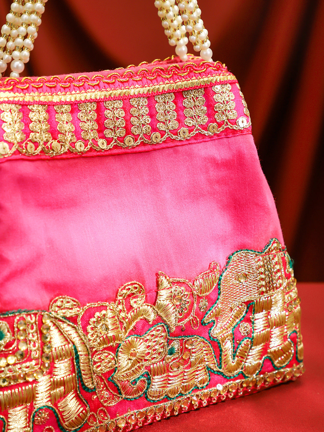 Rubans Pink Silk Potli Bag with Pearl Handle and Intricate Elephant Motif Embroidery Pink