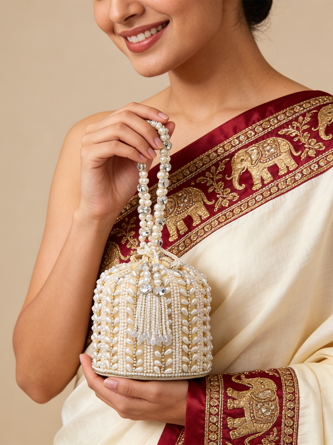 Rubans Off White Coloured Potli Bag With Golden Embroided Design And Pearls. Off White