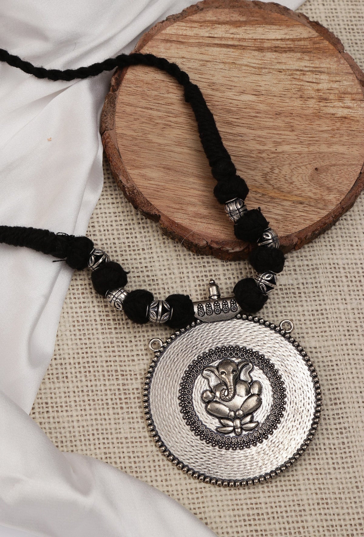 Rustic Charm: Ganesha Silver Pendant with Tribal Dori
