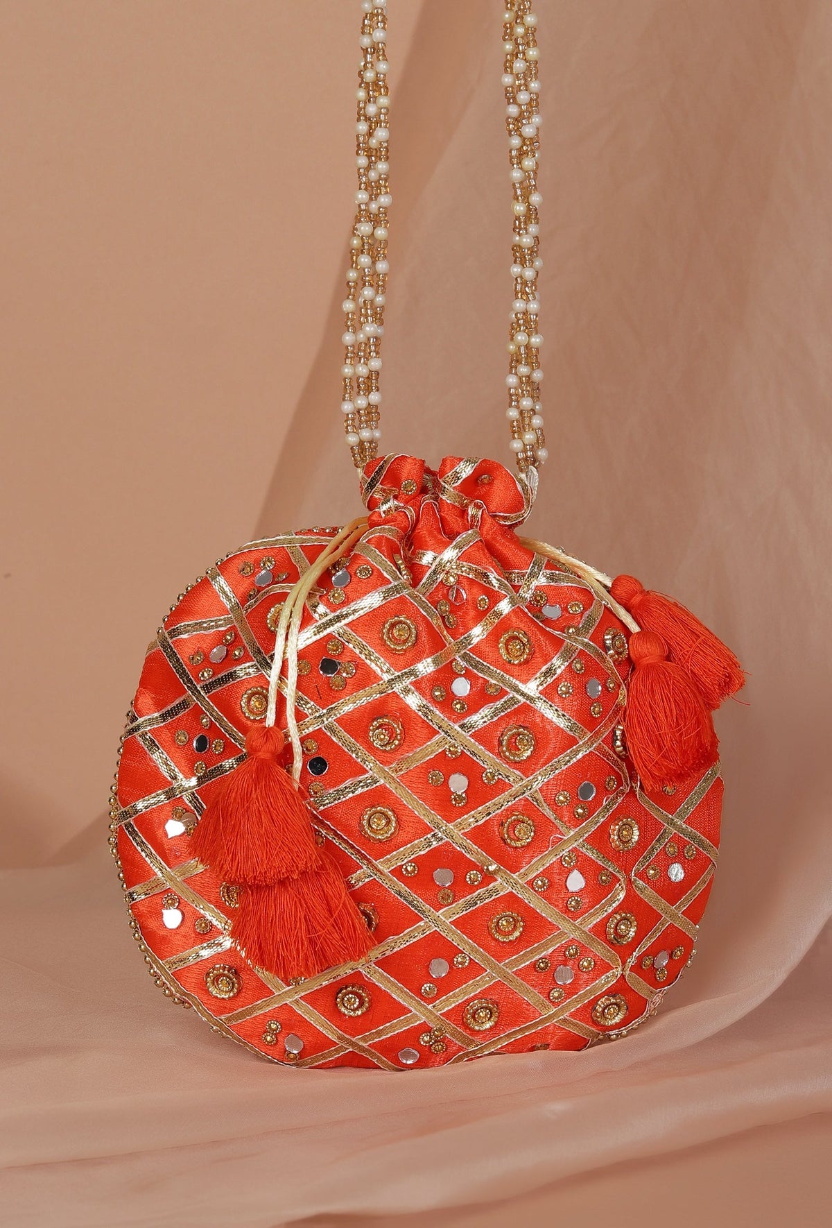 Glimmering Orange Potli with Gota and Glass Stone Work